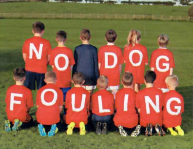Children stood with T-shirts reading 'No Dog Fouling'